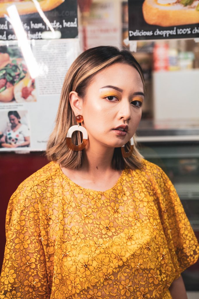 Woman outside a store wearing Lê Tâm.